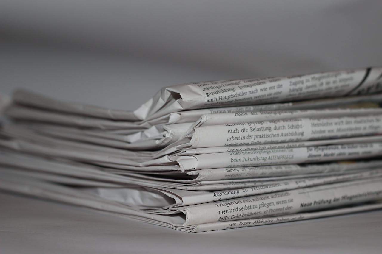 who-we-are A close-up image of folded newspapers, perfect for news or journalism themes.